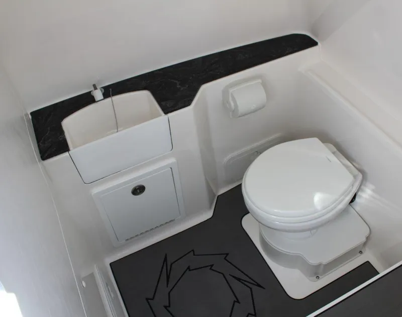 Slide: The Image of 2025 Fountain 32 NX boat bathroom with toilet and sink, featuring modern design and compact layout. - 18