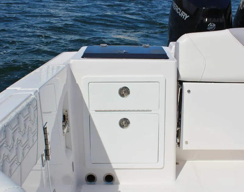 Slide: The Image of 2025 Fountain 32 NX boat interior with storage compartments and Mercury engine. - 21