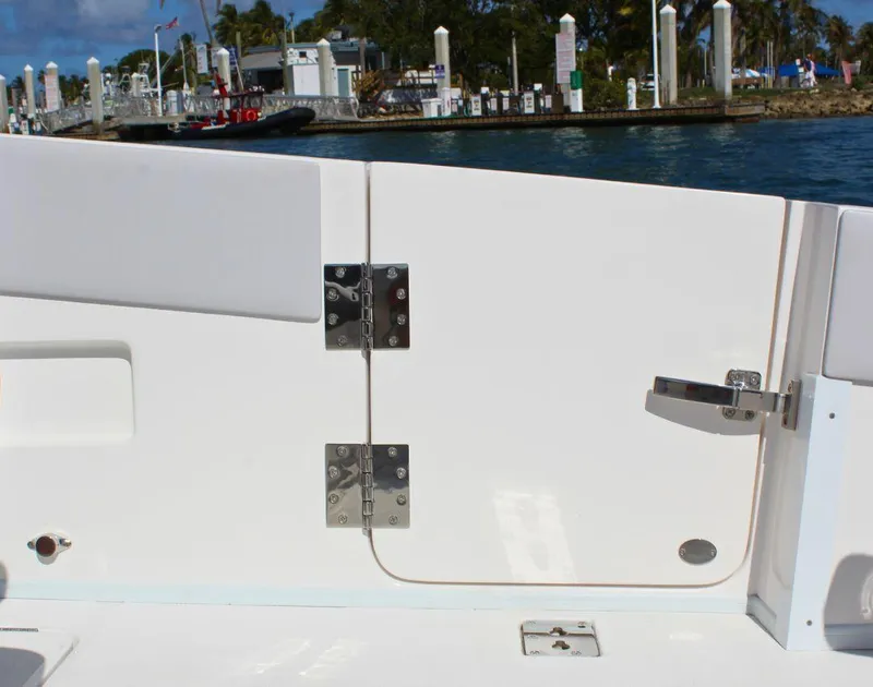 Slide: The Image of Fountain 32 NX 2025 boat detail with dockside view in the background. - 22