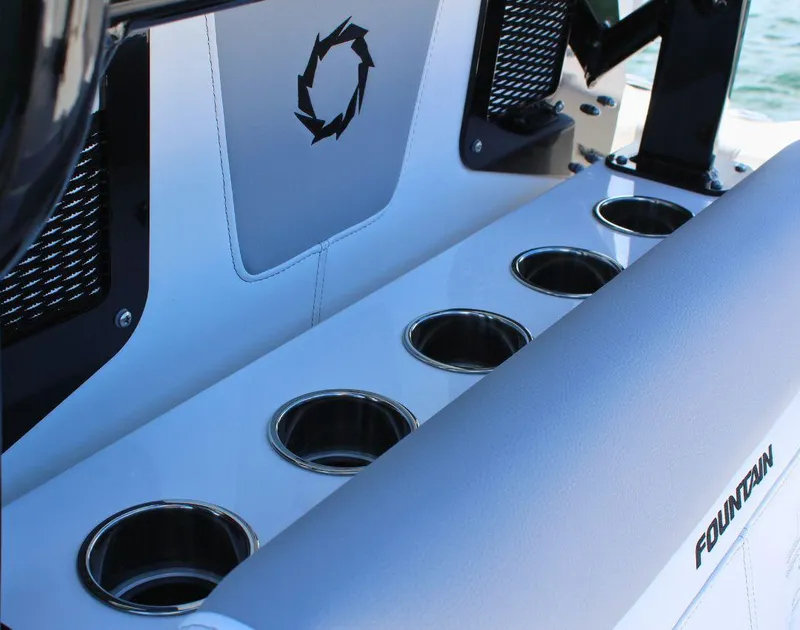 Slide: The Image of 2025 Fountain 32 NX boat interior with multiple stainless steel cup holders. - 25