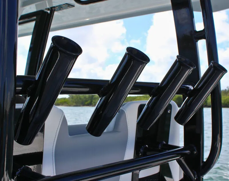 Slide: The Image of 2025 Fountain 32 NX boat rod holders against a scenic water backdrop. - 27