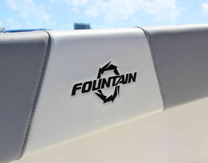 Slide: The Image of Fountain 32 NX 2025 boat logo on white and gray upholstery. - 28