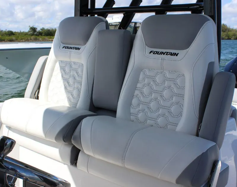 Slide: The Image of Luxury seating on 2025 Fountain 32 NX boat, featuring stylish gray and white upholstery. - 32