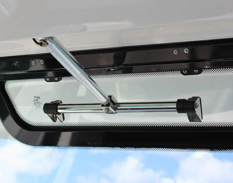 Slide: The Image of 2025 Fountain 32 NX boat window mechanism with chrome support rod and clear sky view. - 37