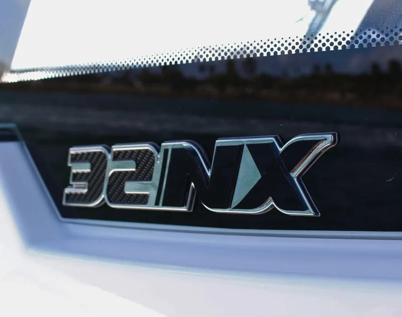 Slide: The Image of Close-up of 2025 Fountain 32 NX logo on a sleek surface. - 38