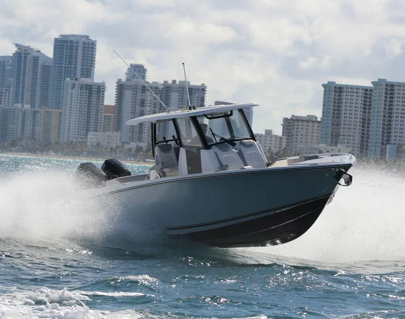 Slide: The Image of 2025 Fountain 32 NX boat cruising on water with city skyline in background. - 4