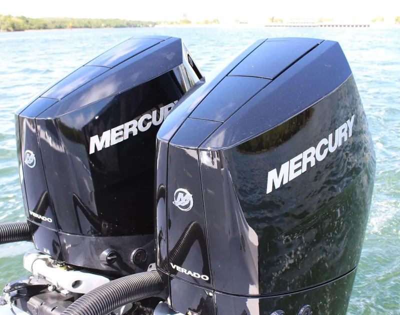 Slide: The Image of Twin Mercury Verado engines on a 2025 Fountain 32 NX boat in water. - 7