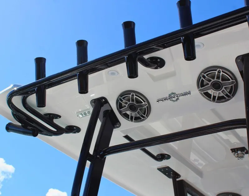 Slide: The Image of 2025 Fountain 38 CC boat speakers and rod holders against blue sky. - 10