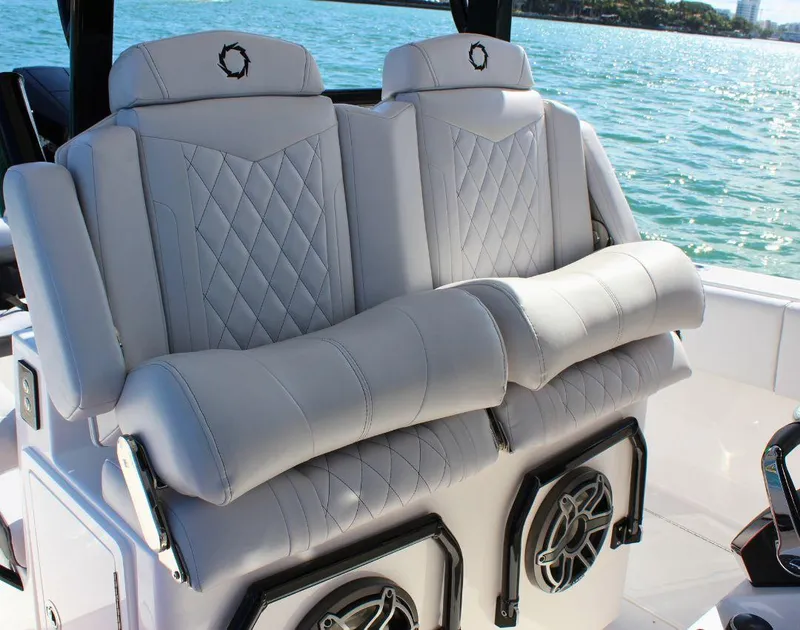 Slide: The Image of Luxury seating on 2025 Fountain 38 CC boat with diamond-stitched upholstery and integrated speakers. - 13