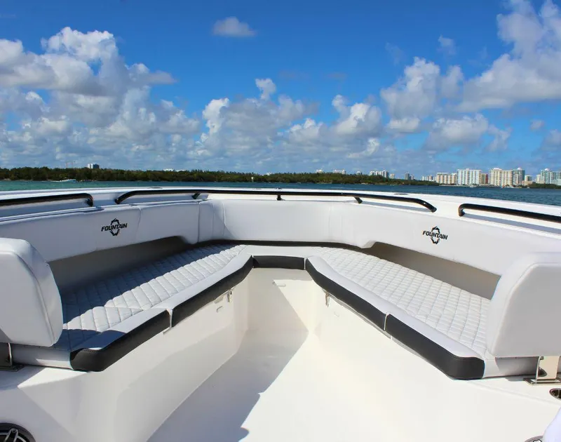 Slide: The Image of 2025 Fountain 38 CC boat interior with white seating, ocean view, and blue sky. - 20