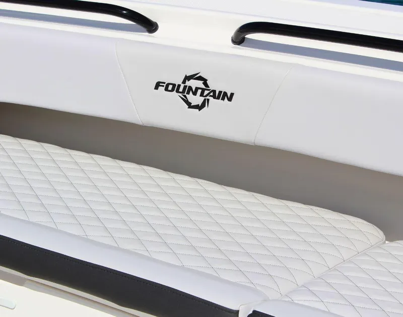 Slide: The Image of 2025 Fountain 38 CC boat interior with white quilted seating and logo. - 21