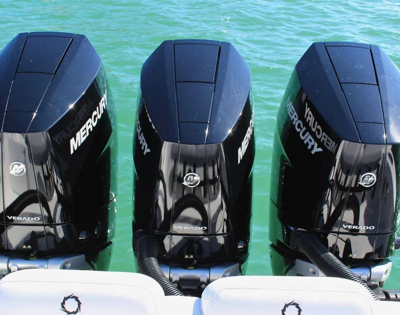 Slide: The Image of Triple Mercury Verado engines on 2025 Fountain 38 CC boat in clear water. - 7