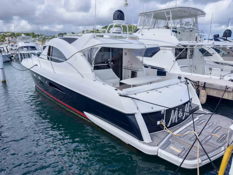 The Image of Riviera 50SY 2012 yacht docked at marina, featuring sleek design and modern amenities. - 1