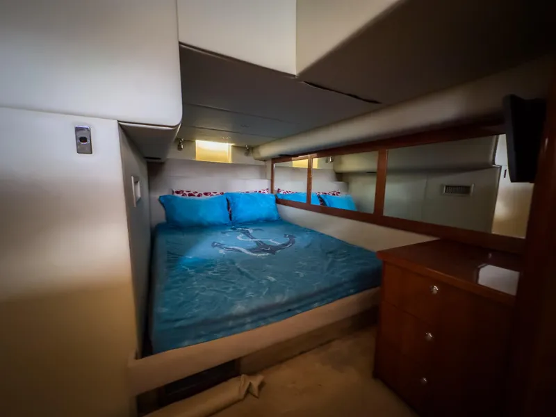 Slide: The Image of Luxurious bedroom interior of 2012 Riviera 50SY yacht with blue bedding and wooden accents. - 10