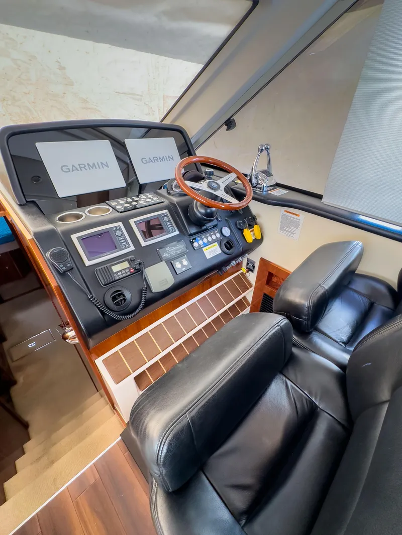 Slide: The Image of Luxurious 2012 Riviera 50SY yacht helm with Garmin navigation and leather seating. - 12