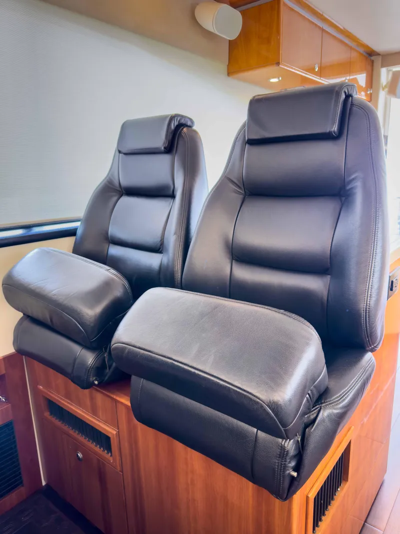 Slide: The Image of Luxurious black leather seats in a 2012 Riviera 50SY yacht interior. - 14