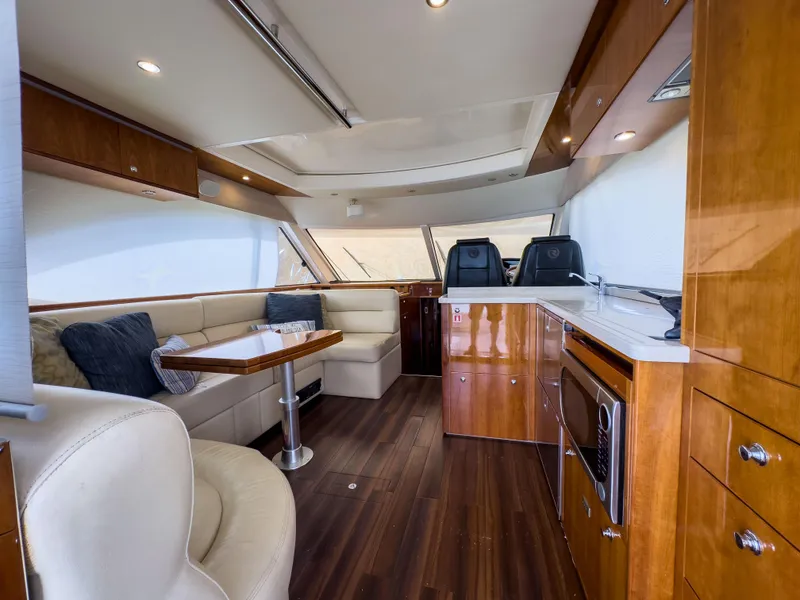 Slide: The Image of Luxurious interior of 2012 Riviera 50SY yacht with elegant wood finishes and modern seating. - 15