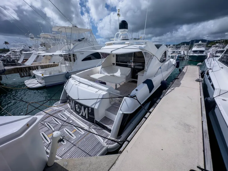 Slide: The Image of 2012 Riviera 50SY yacht docked at marina under cloudy sky. - 16