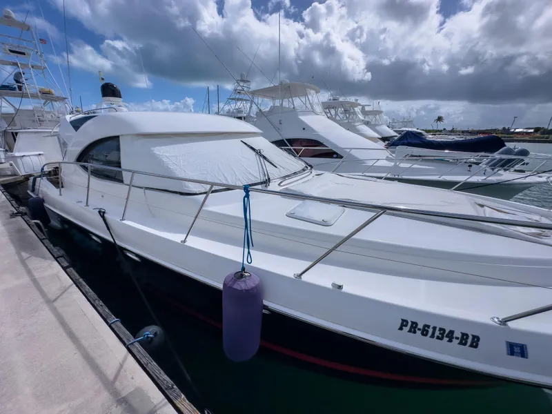 Slide: The Image of 2012 Riviera 50SY yacht docked at marina under cloudy sky. - 17