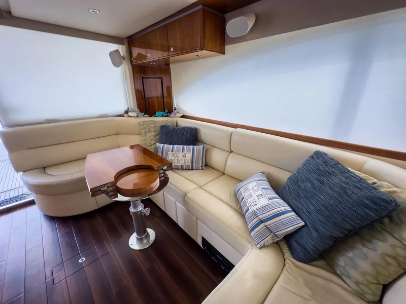 Slide: The Image of Luxurious interior of 2012 Riviera 50SY yacht with plush seating and elegant wooden table. - 3