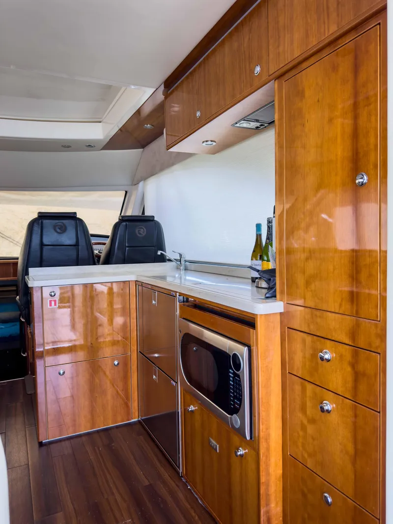 Slide: The Image of Luxurious 2012 Riviera 50SY yacht interior with modern kitchen and wooden cabinetry. - 4