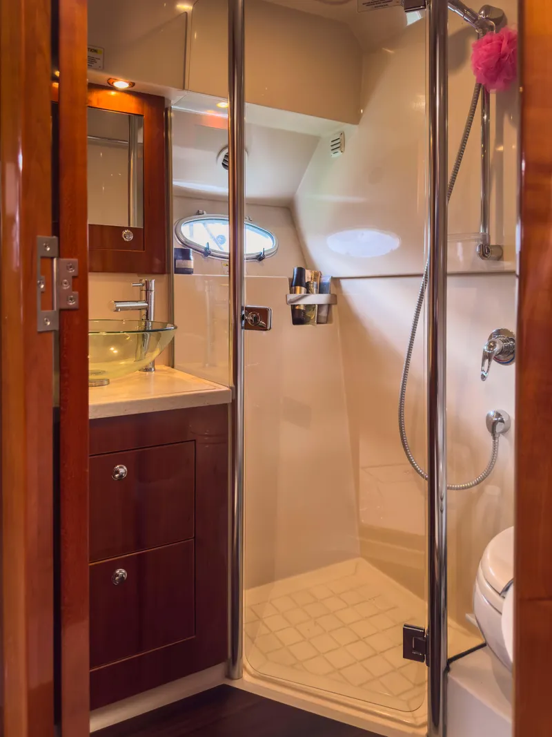Slide: The Image of Luxurious bathroom in 2012 Riviera 50SY yacht with glass shower and wooden cabinetry. - 6