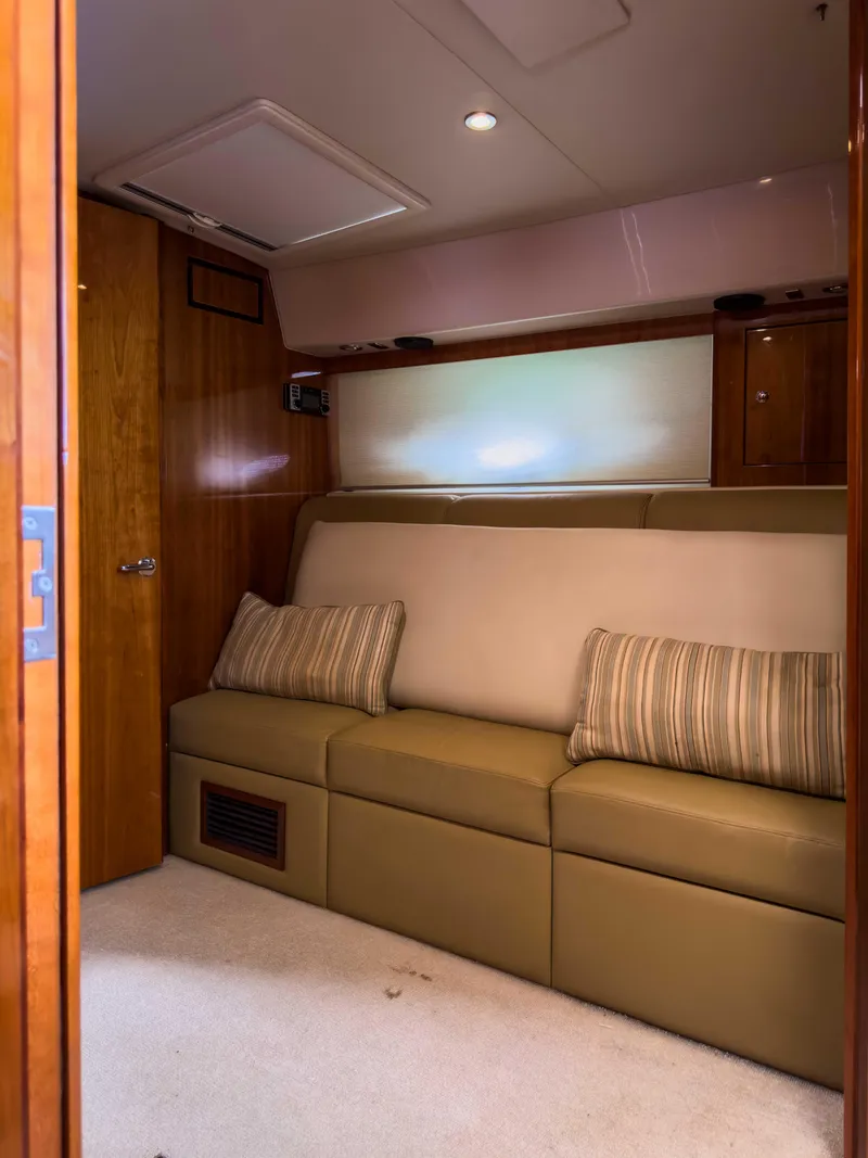 Slide: The Image of Interior of 2012 Riviera 50SY yacht with beige sofa and striped cushions. - 7