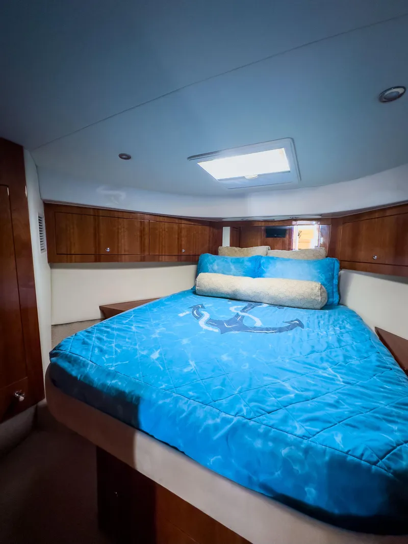 Slide: The Image of Luxurious bedroom interior of 2012 Riviera 50SY yacht with blue bedding. - 8