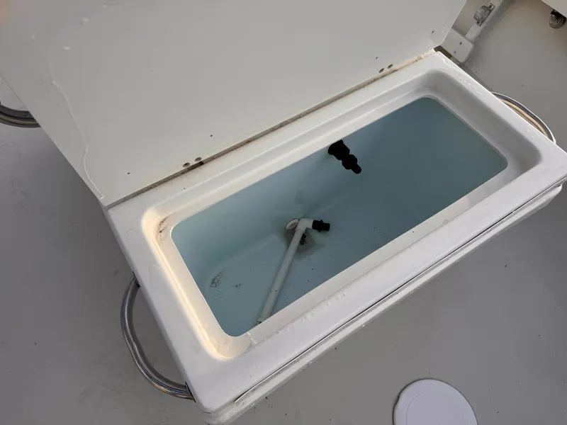 Slide: The Image of Open storage compartment on 2017 Parker 1801 Center Console boat. - 15