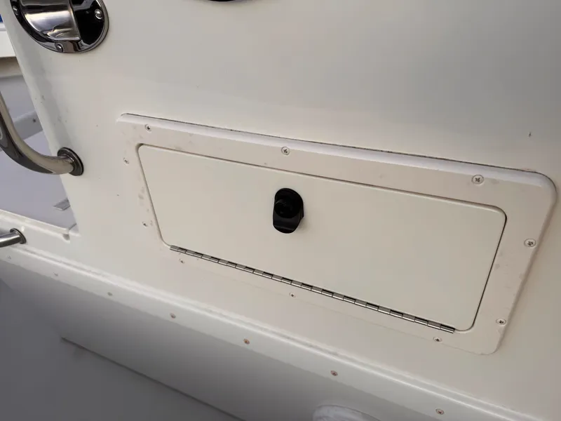 Slide: The Image of 2017 Parker 1801 Center Console boat storage compartment with handle. - 16