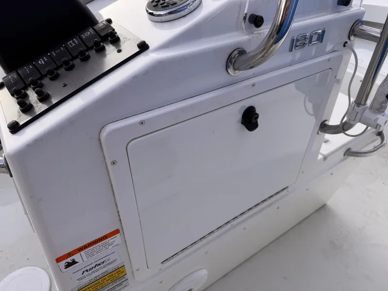 Slide: The Image of 2017 Parker 1801 Center Console boat dashboard with control panel and storage compartment. - 18