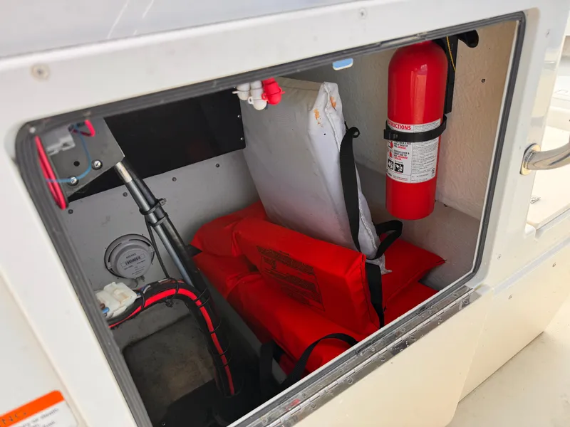 Slide: The Image of Storage compartment of a 2017 Parker 1801 Center Console with safety equipment. - 19