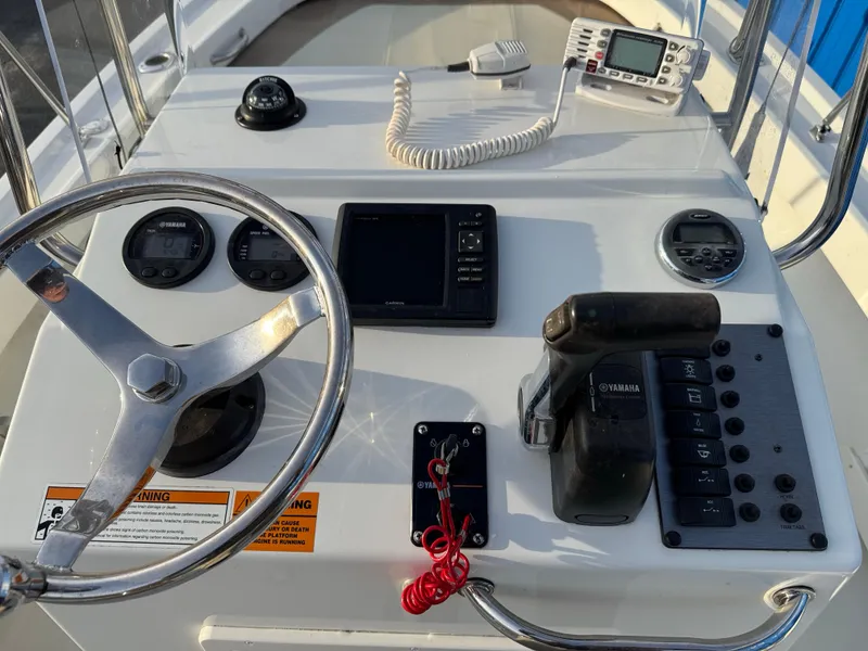 Slide: The Image of 2017 Parker 1801 Center Console boat dashboard with steering wheel and controls. - 27