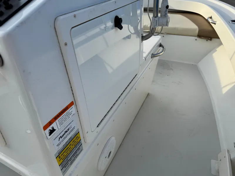 Slide: The Image of 2017 Parker 1801 Center Console boat interior with storage compartment and safety labels. - 5