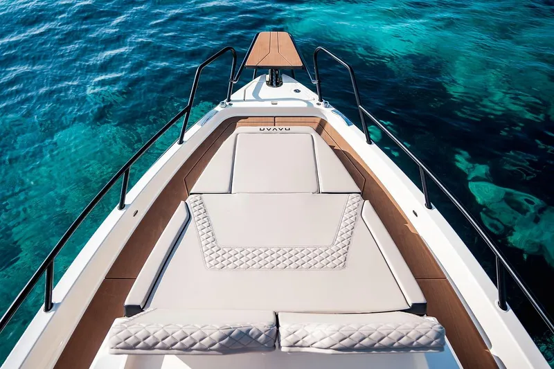 Slide: The Image of 2025 Navan C30 boat docked by a serene lake with lush greenery. - 27