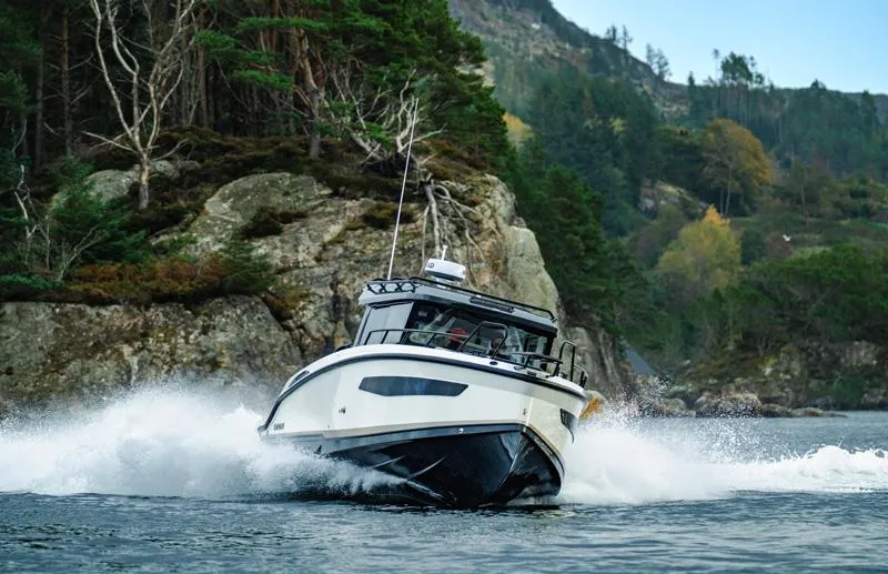 Slide: The Image of 2025 Navan C30 boat navigating through scenic rocky waters. - 4