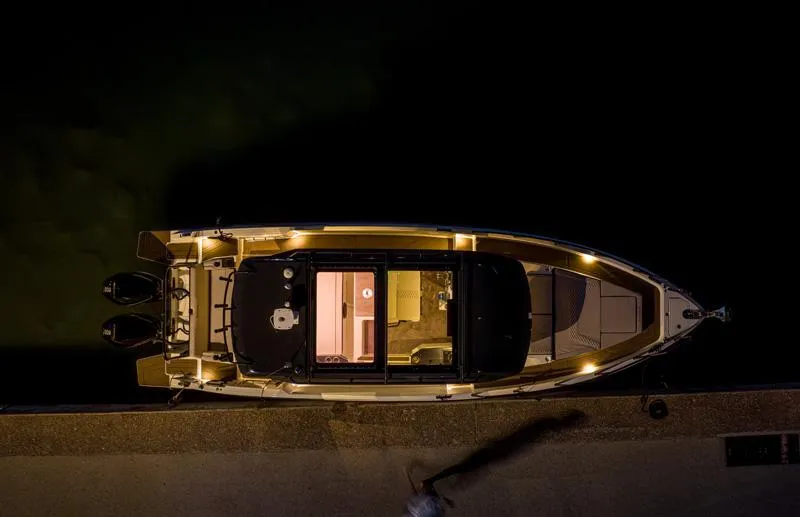 Slide: The Image of Aerial view of 2025 Navan C30 boat docked at night, illuminated with ambient lighting. - 6