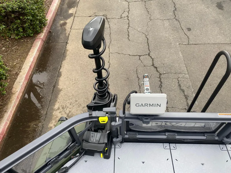 Slide: The Image of 2025 Sea-Doo Switch Fish 18 with Garmin navigation system on a paved surface. - 19