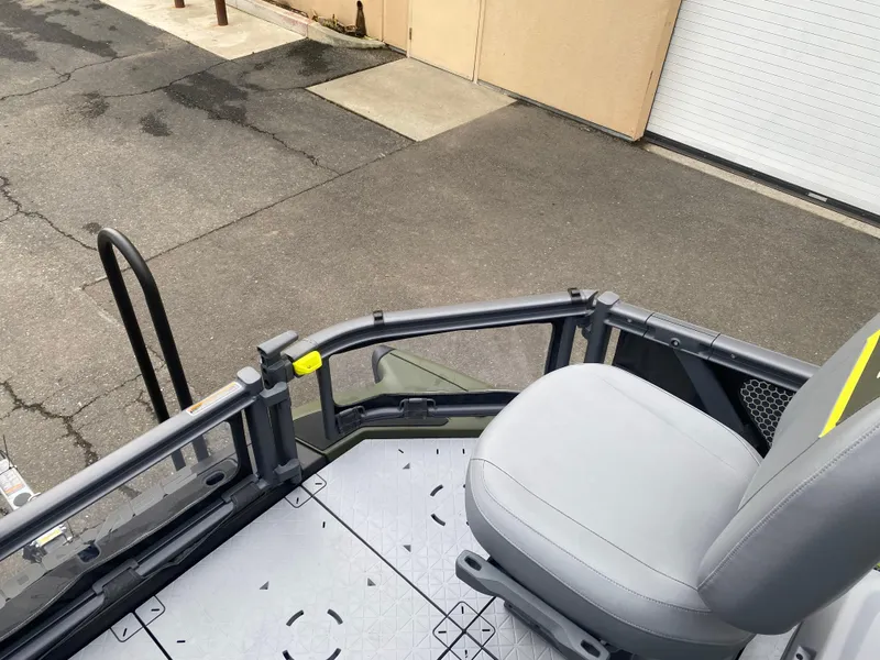 Slide: The Image of 2025 Sea-Doo Switch Fish 18 boat deck with seating, parked on pavement. - 21