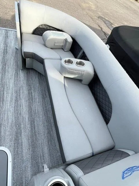 Slide: The Image of 2025 Bennington 21L SB boat interior with gray seating and cup holders. - 11