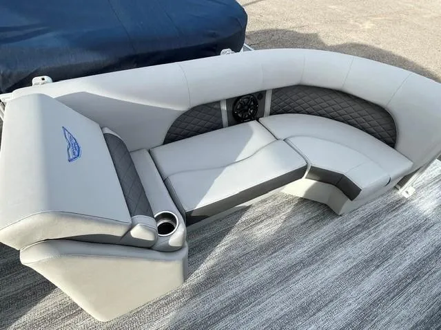 Slide: The Image of 2025 Bennington 21L SB boat seating with gray upholstery and cup holders. - 12