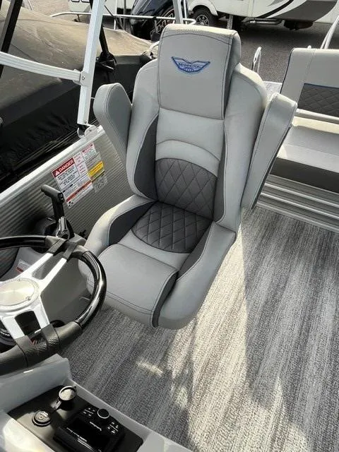 Slide: The Image of 2025 Bennington 21L SB boat interior with luxurious gray captain's chair and steering console. - 15
