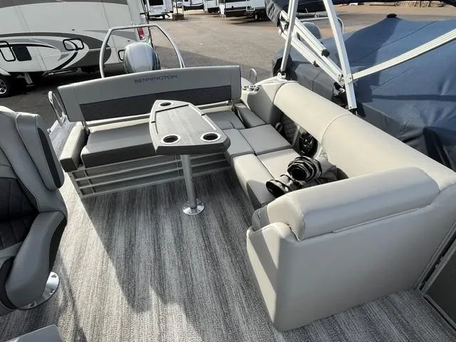 Slide: The Image of 2025 Bennington 21L SB pontoon boat interior with gray seating and table. - 16