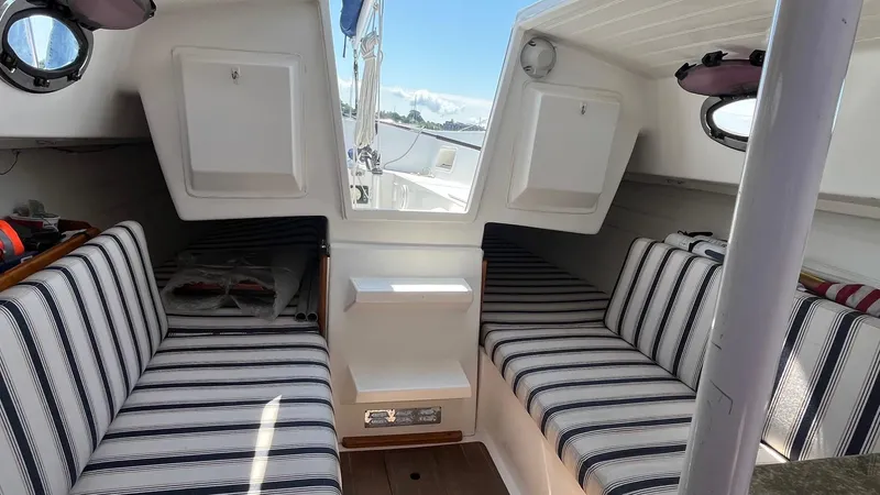 Slide: The Image of 2012 Schock Harbor 25 interior with striped seating and nautical decor. - 14
