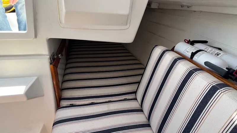 Slide: The Image of Interior of 2012 Schock Harbor 25 sailboat with striped cushions and safety equipment. - 16