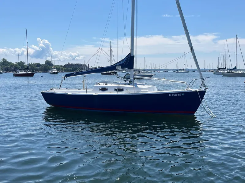 Slide: The Image of 2012 Schock Harbor 25 sailboat on calm water, surrounded by other boats. - 2