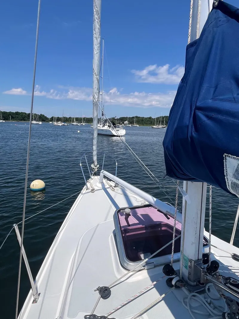Slide: The Image of 2012 Schock Harbor 25 sailboat on calm water with clear blue sky. - 3