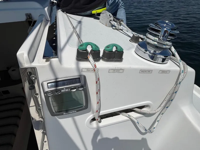 Slide: The Image of 2012 Schock Harbor 25 sailboat cockpit with winch, ropes, and navigation display. - 8