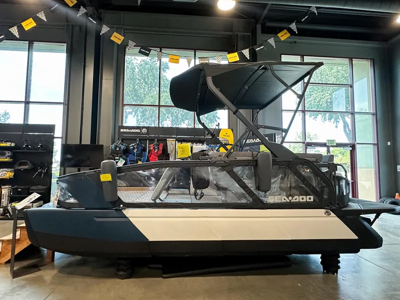 Slide: The Image of 2025 Sea-Doo Switch Sport 18 displayed indoors with accessories and promotional banners. - 0