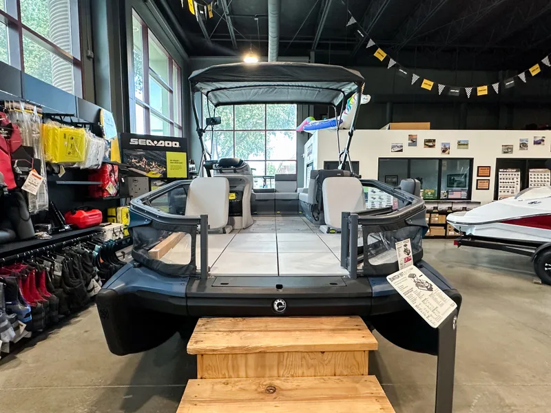 Slide: The Image of 2025 Sea-Doo Switch Sport 18 displayed in showroom with accessories and promotional materials. - 1